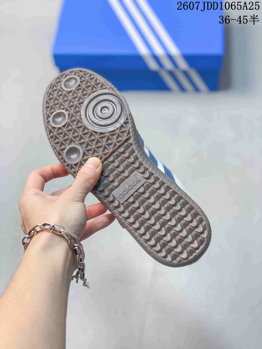 Close view of the textured gum-colored outsole with circular and geometric tread details.