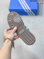 Close view of the textured gum-colored outsole with circular and geometric tread details.