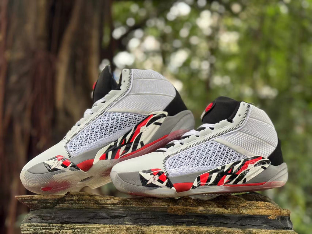 Pair of high-top shoes displayed from angled side views, highlighting the white, gray, black, and red design.