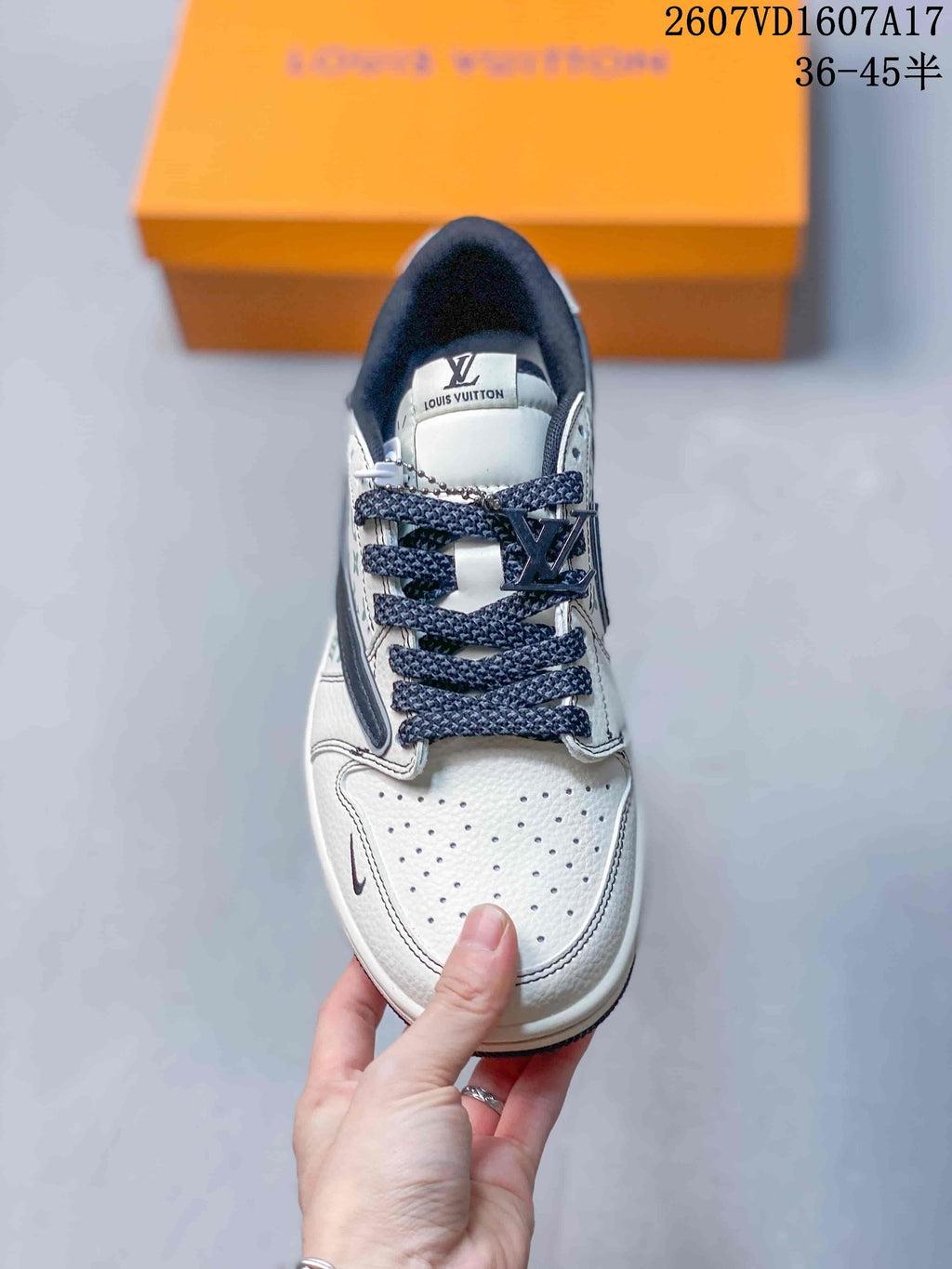 Top view showing the perforated white toe box, navy laces, and branded tongue.