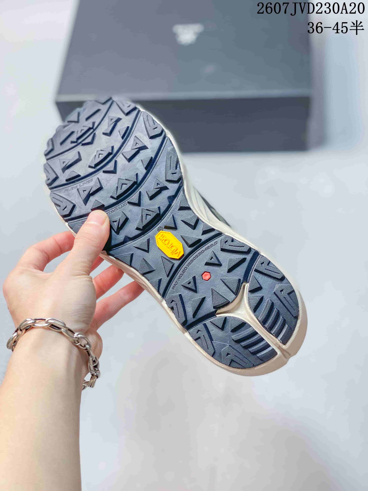 Close view of the hiking shoe outsole showing a deep geometric tread pattern and a yellow outsole insert.