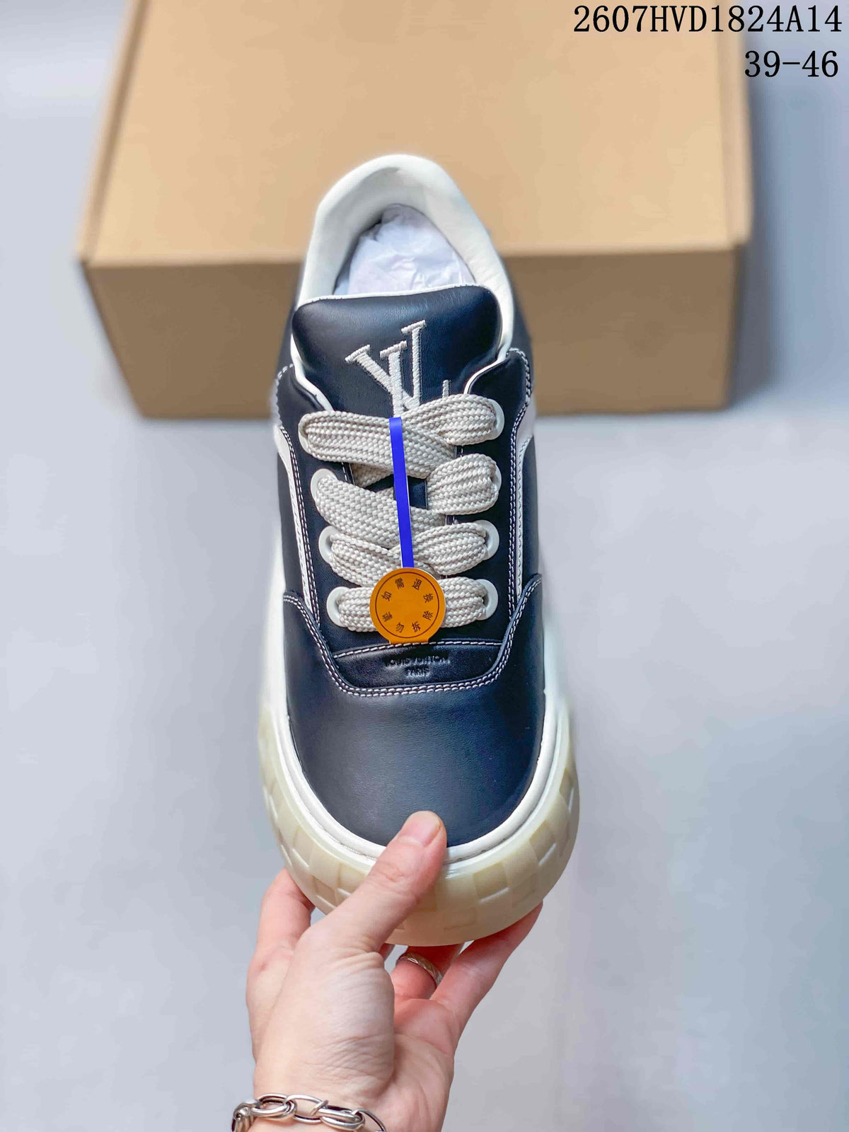 Top view showing the navy toe, white laces, tongue lettering, and contrast stitching.