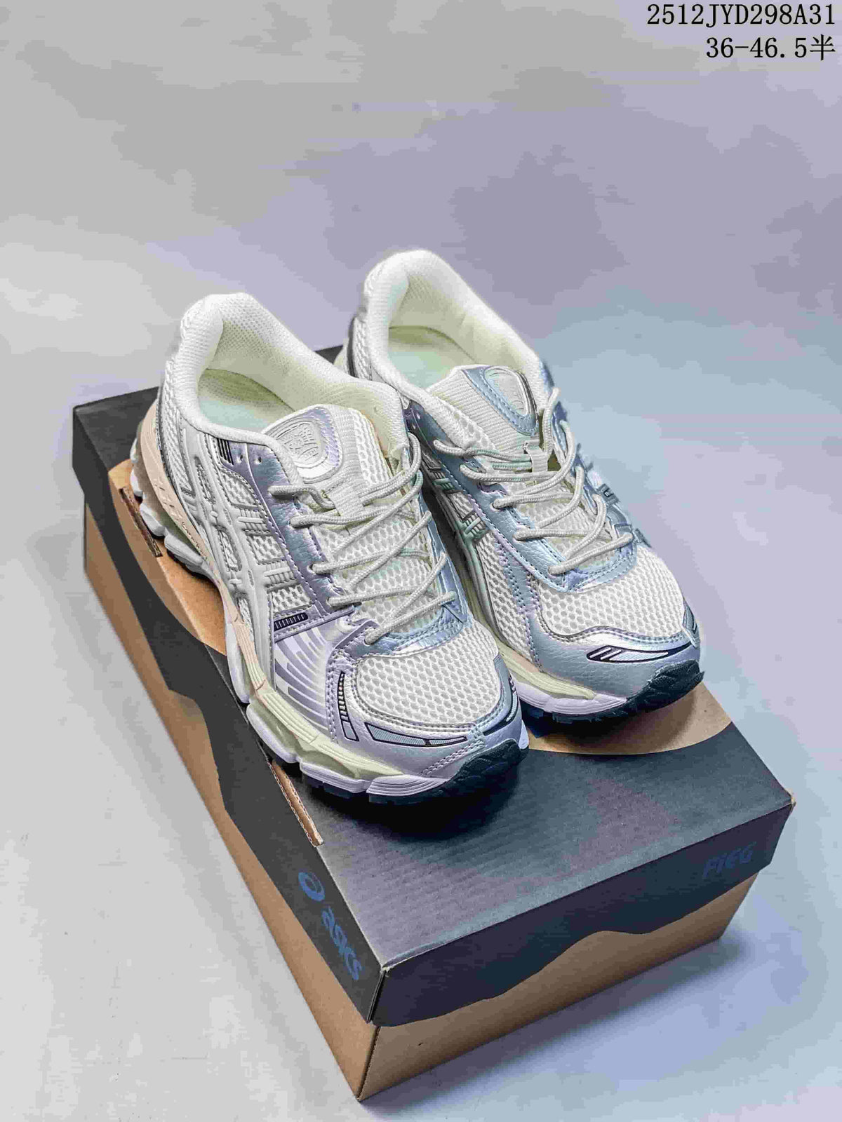 Pair of silver and white ASICS Gel-Kayano 12.1 shoes with pale blue accents