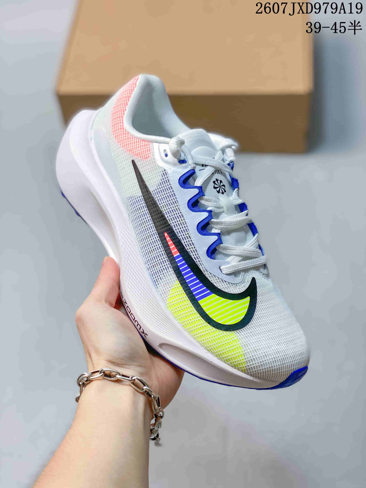 Angled side view of the white Nike Zoom Fly 5 PRM running shoe with black, blue and neon yellow Swoosh accents.