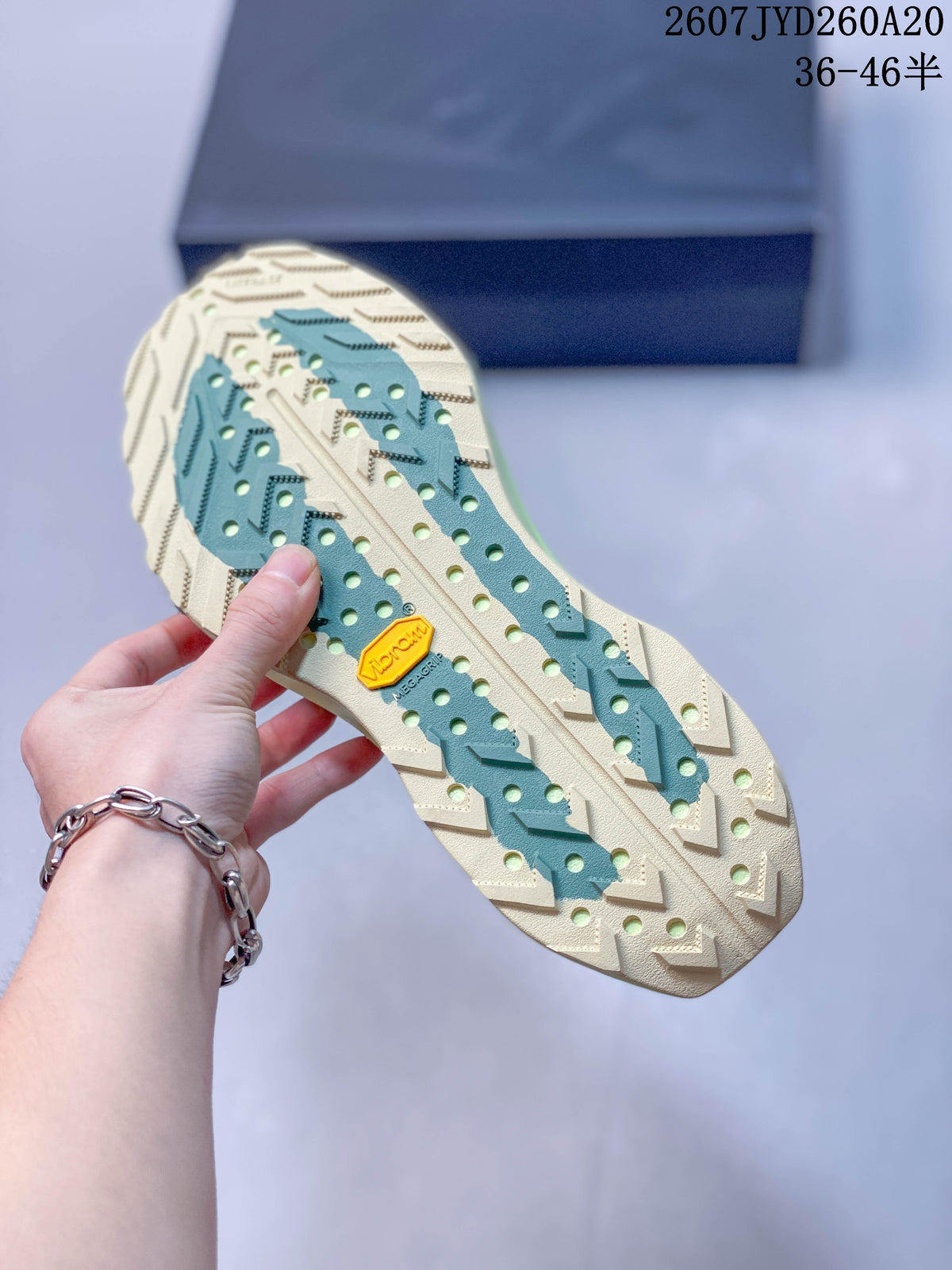 Close-up of the trail sneaker outsole showing a lugged tread pattern and visible Vibram mark.