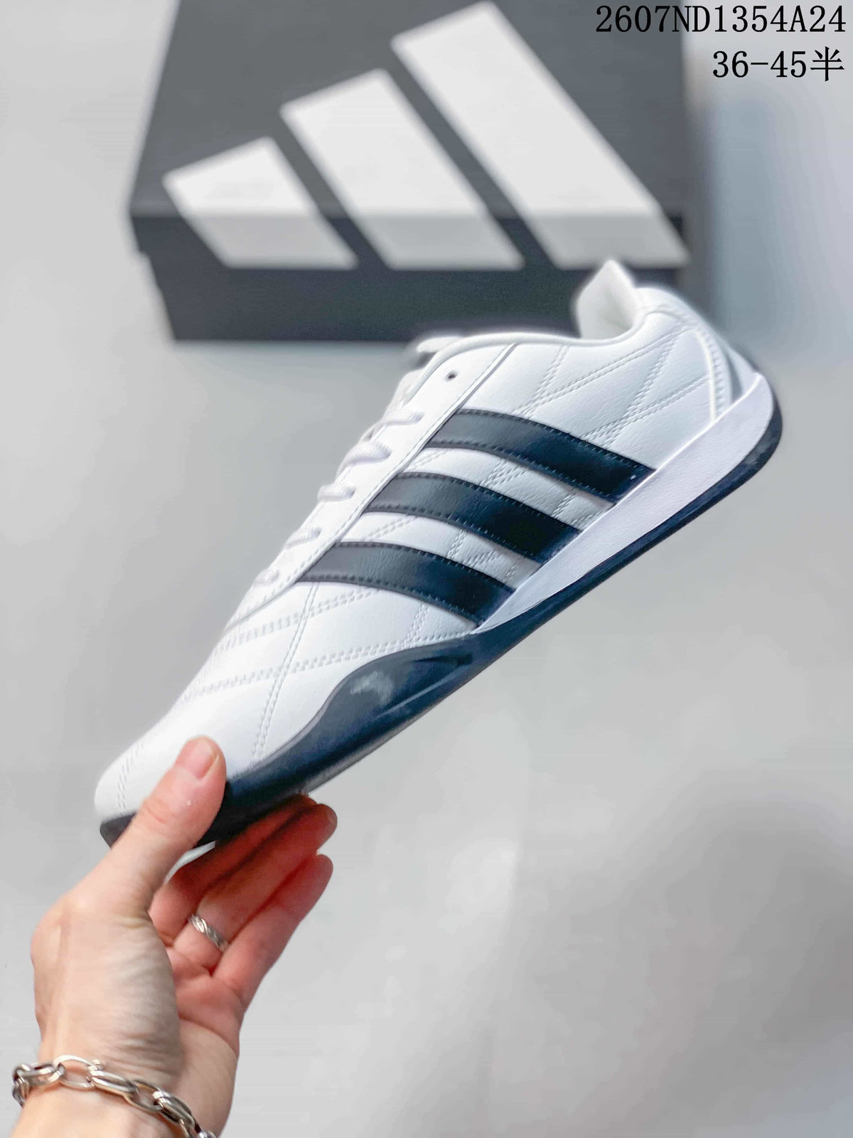 Side view of the white low-top sneaker with black three-stripe detailing and dark outsole.
