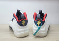 Rear view of the white Nike Air Foamposite One sneakers with navy and red details.