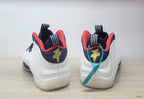 Rear view of the white Nike Air Foamposite One sneakers with navy and red details.