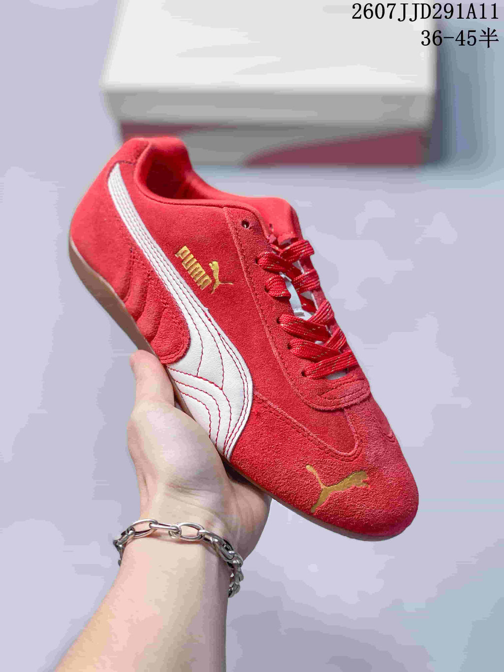 Red PUMA sneaker with a white side stripe, gold branding, red laces, and a gum-colored outsole.