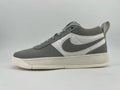 Side view of a gray and white Nike low-top sneaker with a Swoosh and speckled off-white sole