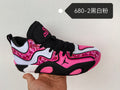 Jordan sneaker in black, white, and pink with patterned side panels, black laces, a Jumpman logo, and a number 23 design on the tongue