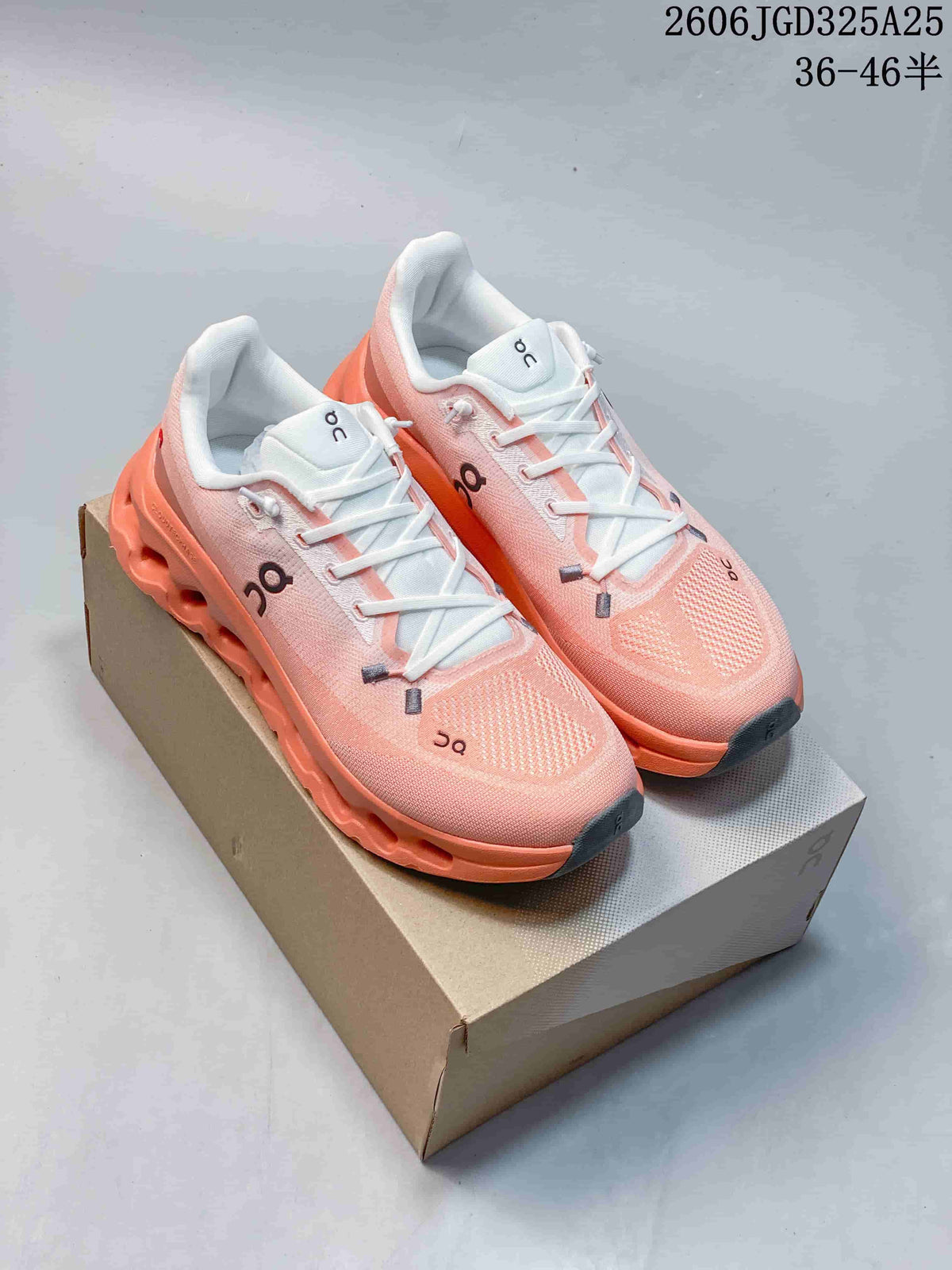 Pair of pink and coral On Cloudsurfer sneakers displayed on a shoebox, with the size range text 36–46 visible at the top.