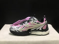 Side view of pink, black, and white OFF-WHITE Be Right Back sneakers with layered arrow-shaped side detailing.