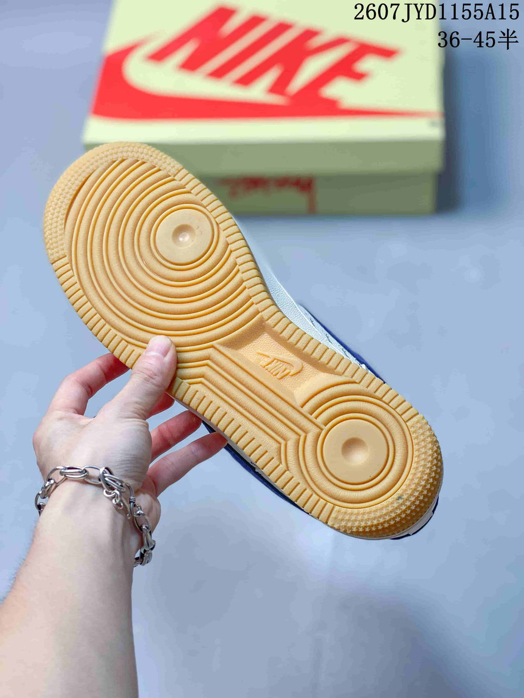 Close-up of the gum-colored rubber outsole showing its circular traction pattern and Nike branding.