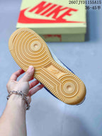 Close-up of the gum-colored rubber outsole showing its circular traction pattern and Nike branding.