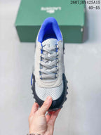 Top view showing the lace-up construction, white textured toe area, black toe overlay, and blue lining.