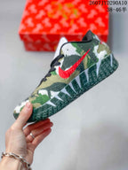 Side view showing the green camouflage-style upper, red Swoosh, and textured outsole.