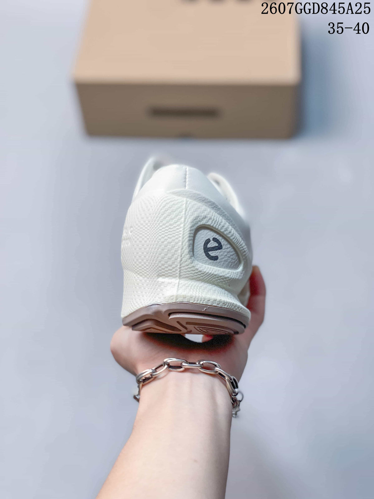 Rear view of a white sneaker showing the padded heel, textured upper, and outsole.