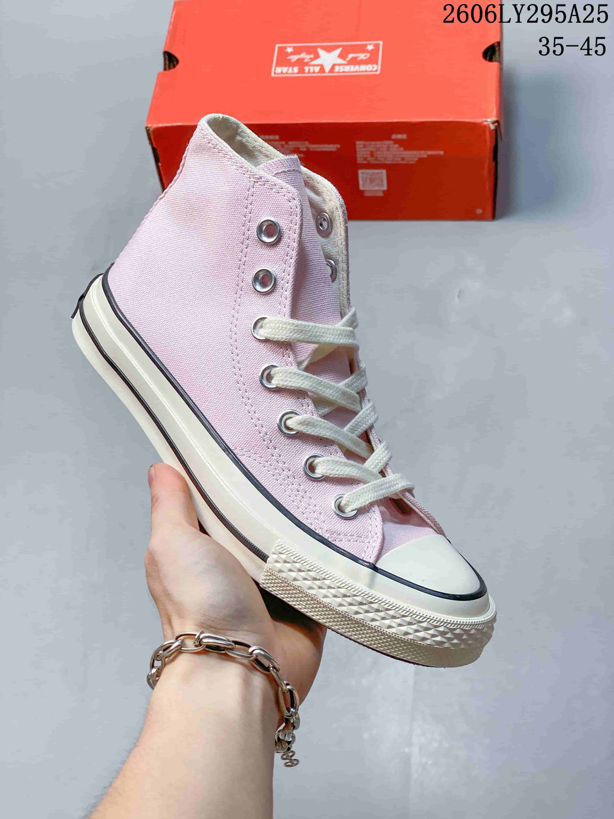 Pale pink high-top sneaker with white laces, metal eyelets, and a white rubber sole; size range 35–45 is printed in the image.