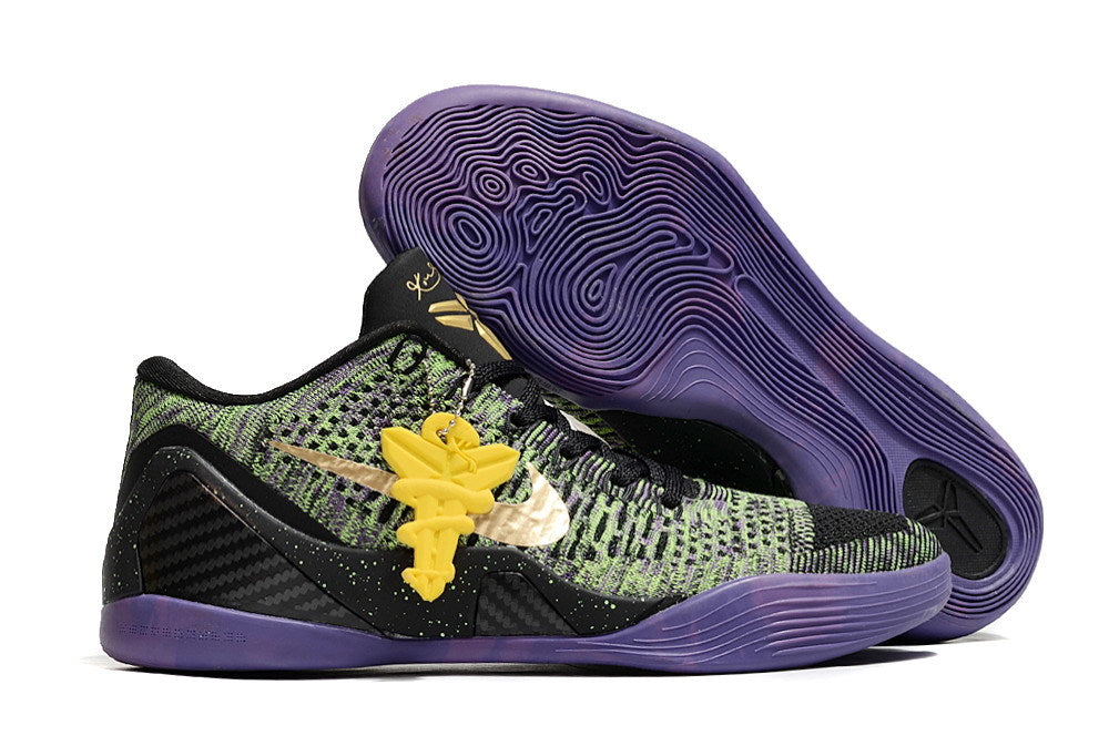 Black, green, and purple shoe with a purple outsole and yellow hanging accent.