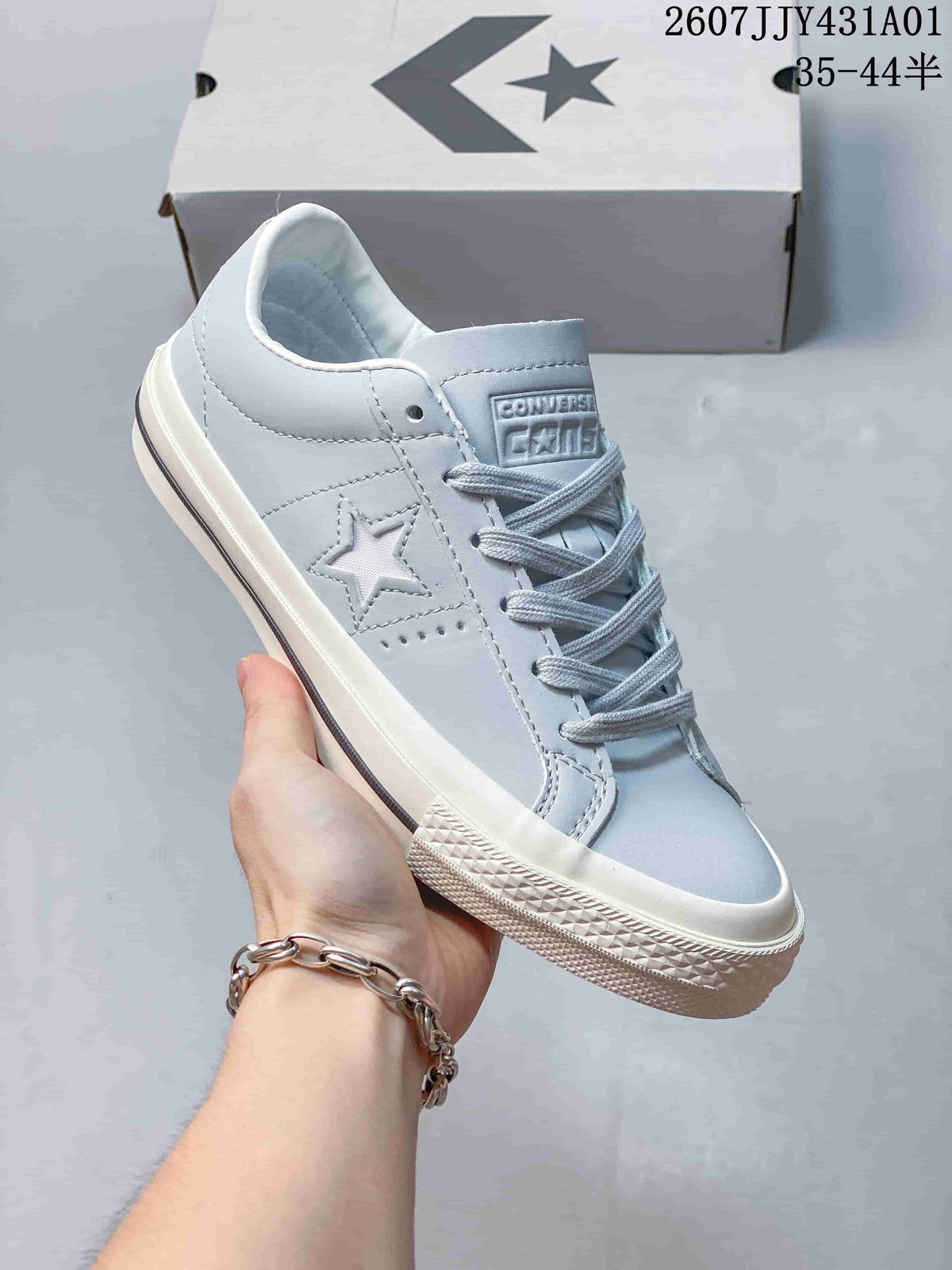 Close-up of a light blue Converse One Star sneaker showing the star side detail and laces