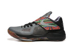 Side view of a gray and black Nike KD 4 shoe with a multicolor patterned strap.
