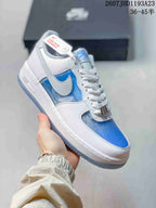 Angled side view showing the white and blue upper, Swoosh, Air midsole detail, and translucent outsole.