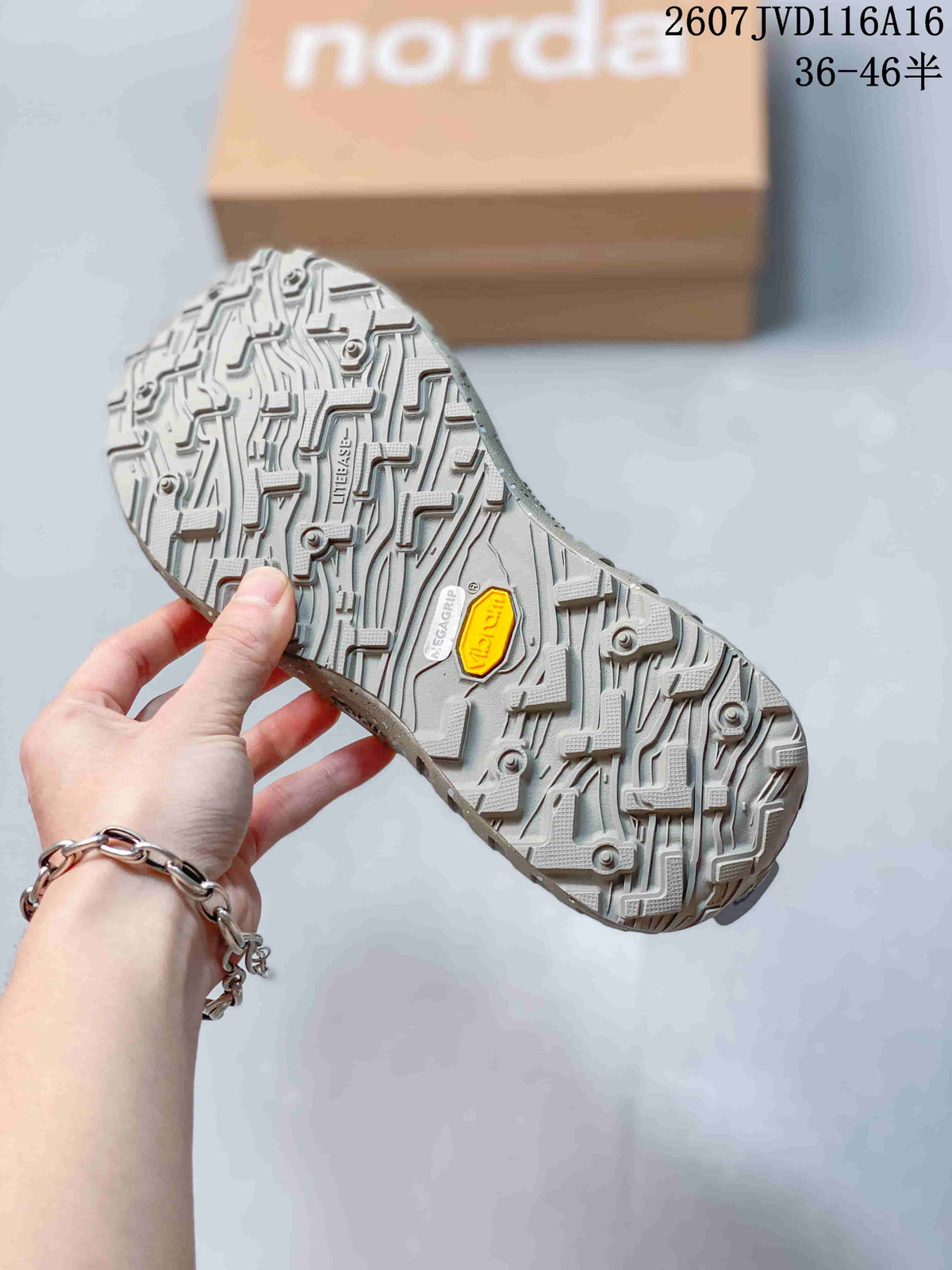 Close-up of the shoe outsole showing a thick, deeply lugged tread pattern and a yellow Vibram-branded insert.