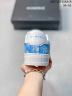 Rear view of a blue and white NUMERIS sneaker showing the branded heel and raised white sole.