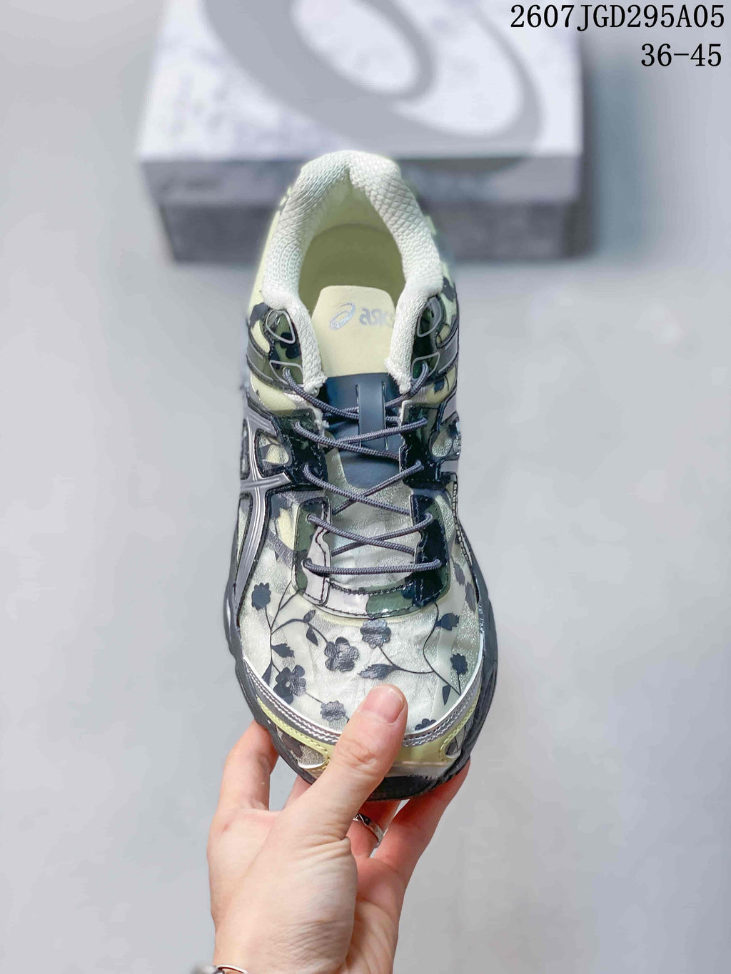 Top view of the sneaker showing the floral toe box, dark laces, padded tongue, and collar.