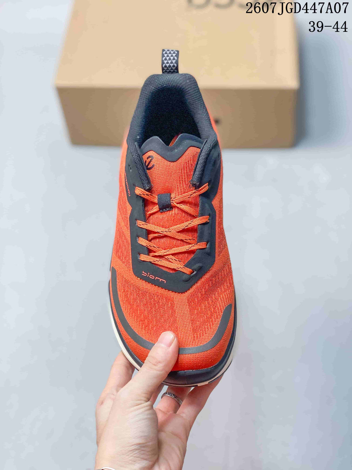Top view of an orange ECCO sneaker showing the dark tongue and eyestay, orange laces, and BIOM marking.
