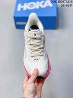 Top view of a white lace-up HOKA Clifton 10 sneaker with pink edging and padded collar; image text shows size range 36–40.5.