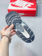 Underside view of a Nike V5 RNR sneaker showing the dark patterned rubber outsole and sculpted midsole.