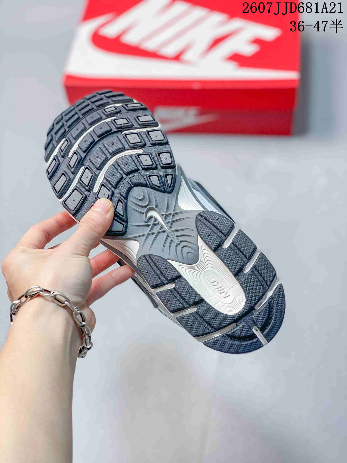 Underside view of a Nike V5 RNR sneaker showing the dark patterned rubber outsole and sculpted midsole.