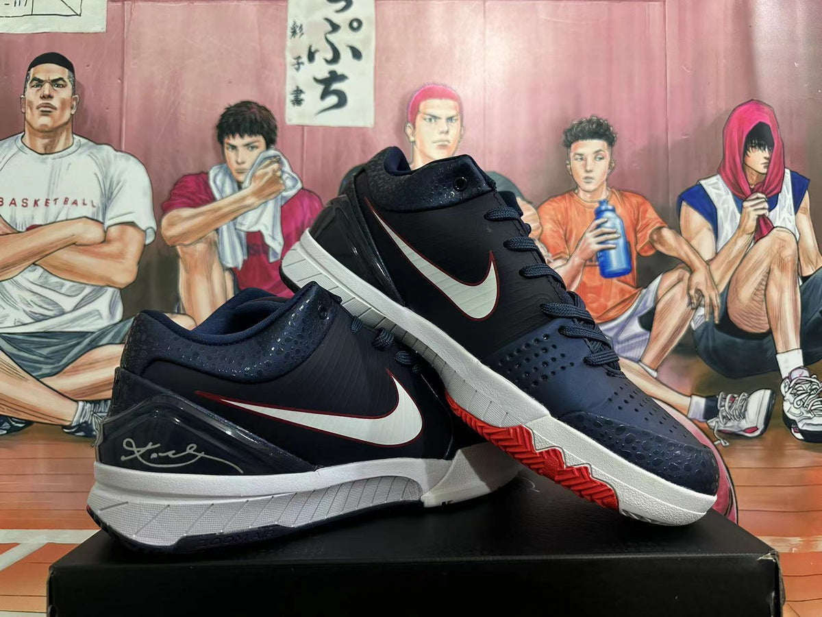 Pair of dark Nike low-top basketball shoes with white Swooshes, white midsoles, and red outsole accents