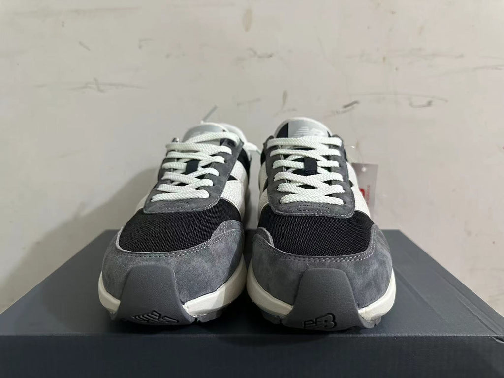 Front view showing the laces and layered toe panels of New Balance U370 sneakers