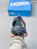 Rear view of a black HOKA Hopara OG sandal showing the heel pull tab, open heel area and layered outsole.