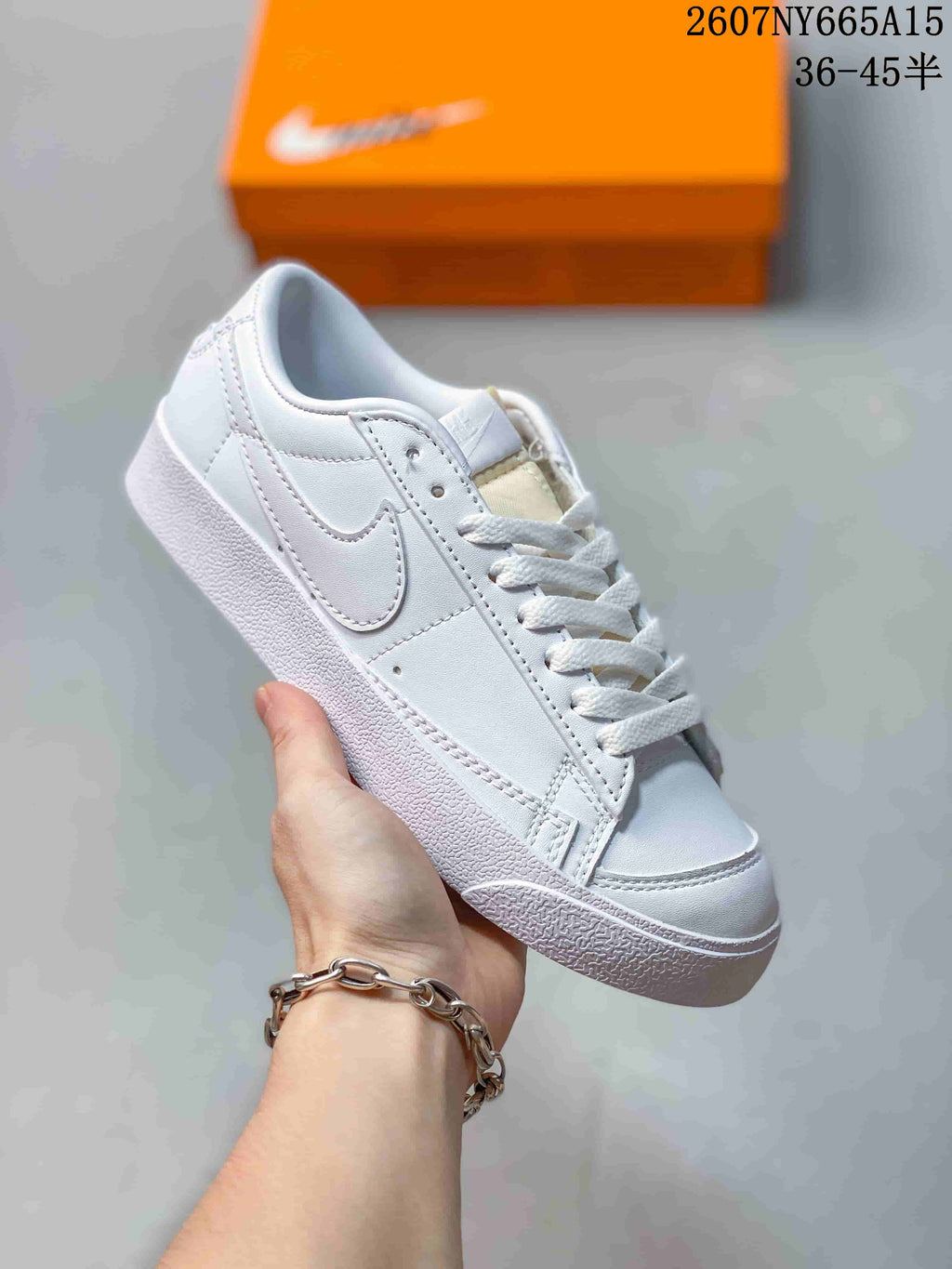 Angled view of a white Nike Blazer Low Premium sneaker with a tonal Swoosh, white laces and a textured rubber sole.