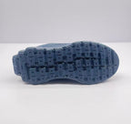Underside view of the dark blue Alo sneaker showing the segmented textured outsole tread.