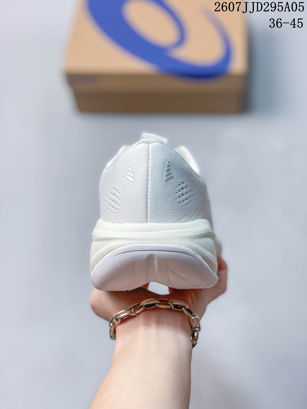 Rear view of the white running shoe showing the padded heel collar, heel construction and outsole.