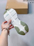 Underside view of an On Cloudpulse 2 sneaker showing the white outsole, green traction sections, and patterned tread.