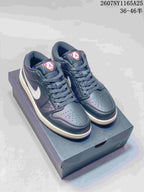 Pair of black and white Jordan low-top sneakers displayed on a shoebox