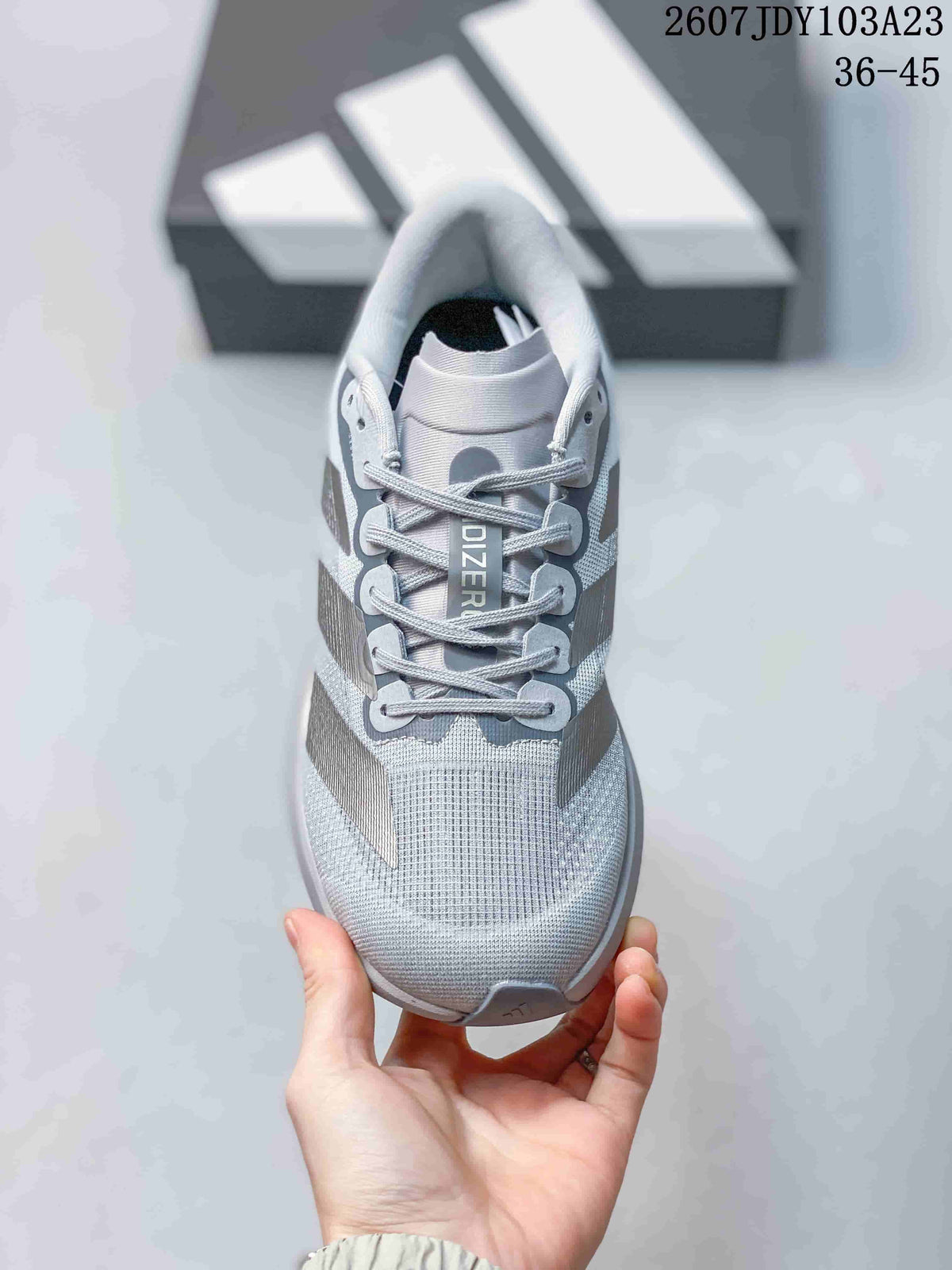 Top view of the running shoe showing the mesh-textured toe box, gray laces, tongue branding, and side stripes.