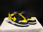 Front three-quarter view of the pair highlighting the black and yellow color blocking and lace tags.
