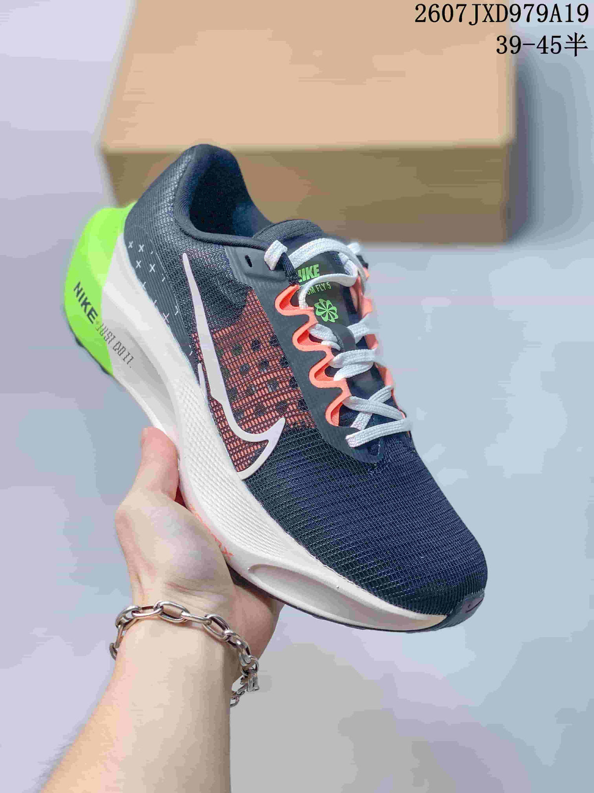 Dark Nike Zoom Fly 5 PRM sneaker with a patterned side panel, pale logo, coral lace accents and a bright green heel.
