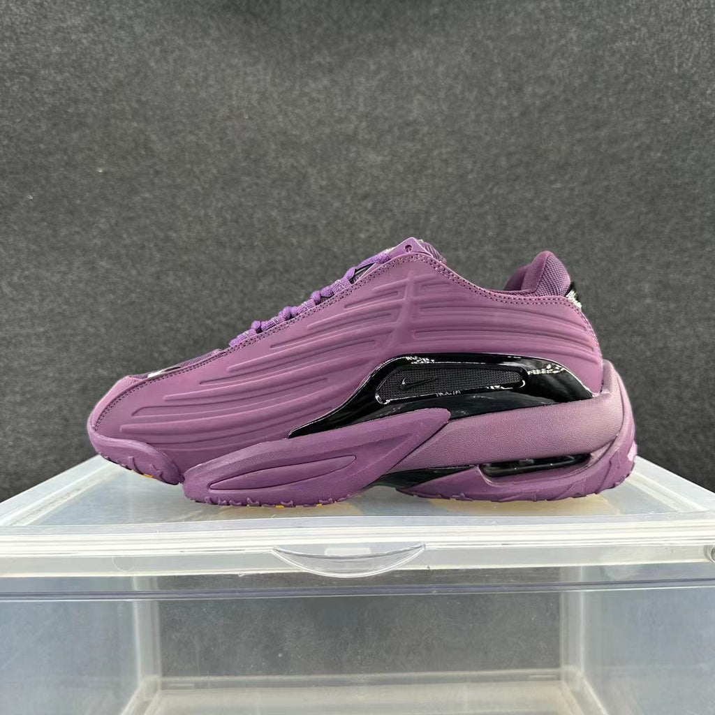Purple low-top sneaker with sculpted side panels and glossy dark side accent
