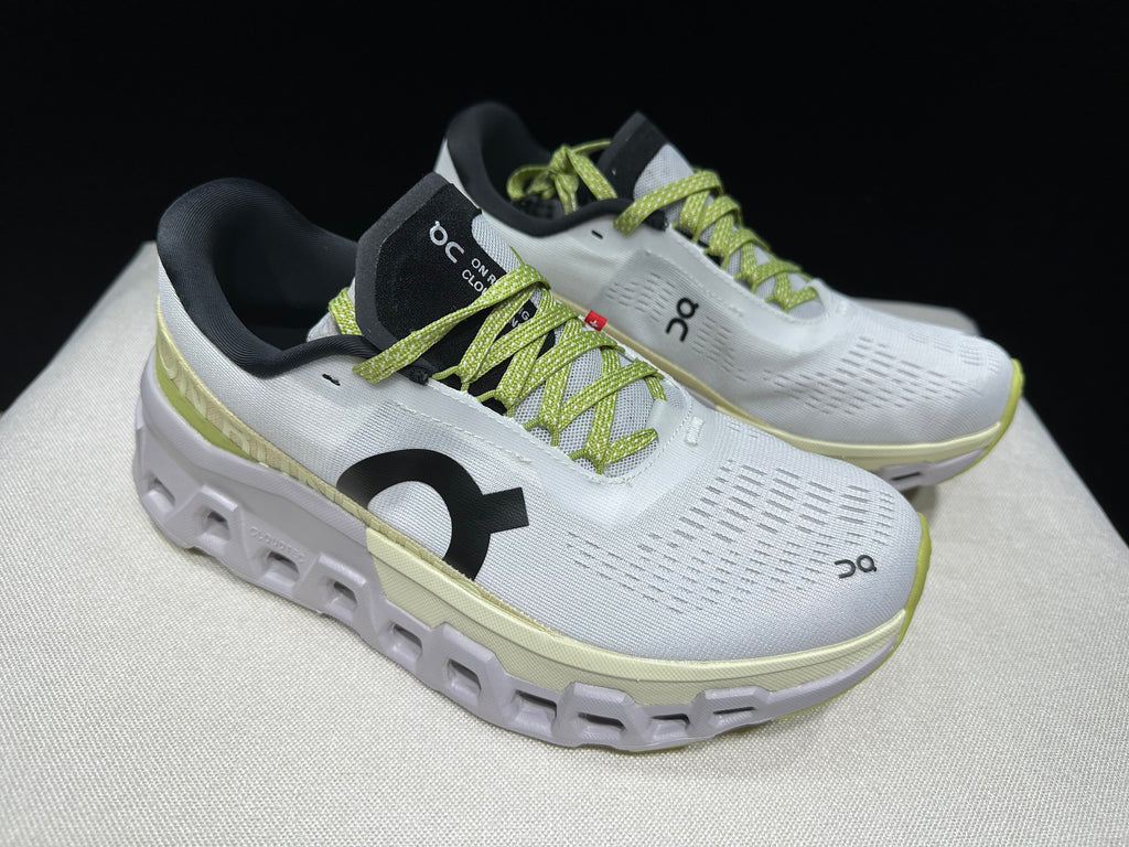 Angled top view of the pair, showing the lime laces and black tongue details.