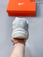 Rear view of a white and grey Nike Initiator sneaker showing the padded heel and layered sole.