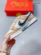 Side view of a low-top sneaker showing layered tan and white panels, a dark textured Swoosh, white midsole, and navy outsole.