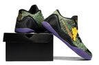Black, green, and purple shoes displayed on a black shoebox.